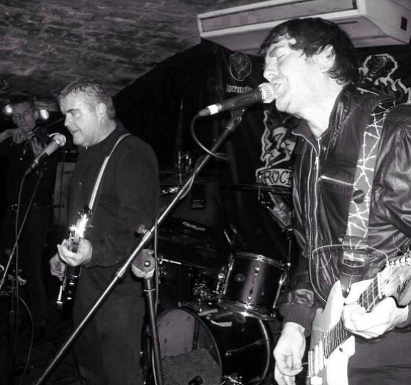Mark Fleming playing in Edinburgh postpunk band Desperation AM, alongside (left to right) Paul Mackie aka Research on violin, Ross Galloway on bass